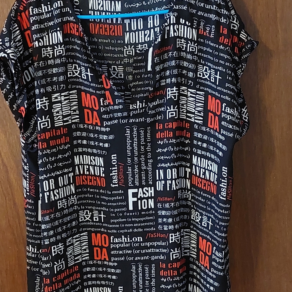 Black short sleeve blouse with red and white writing . Only worn once
